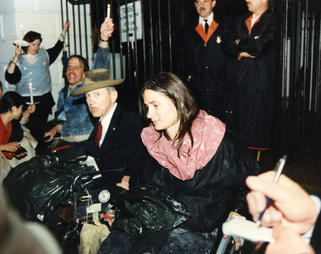 Marca Bristo and Justin Dart leading a candlelight vigil outside the White House in the 1980s.