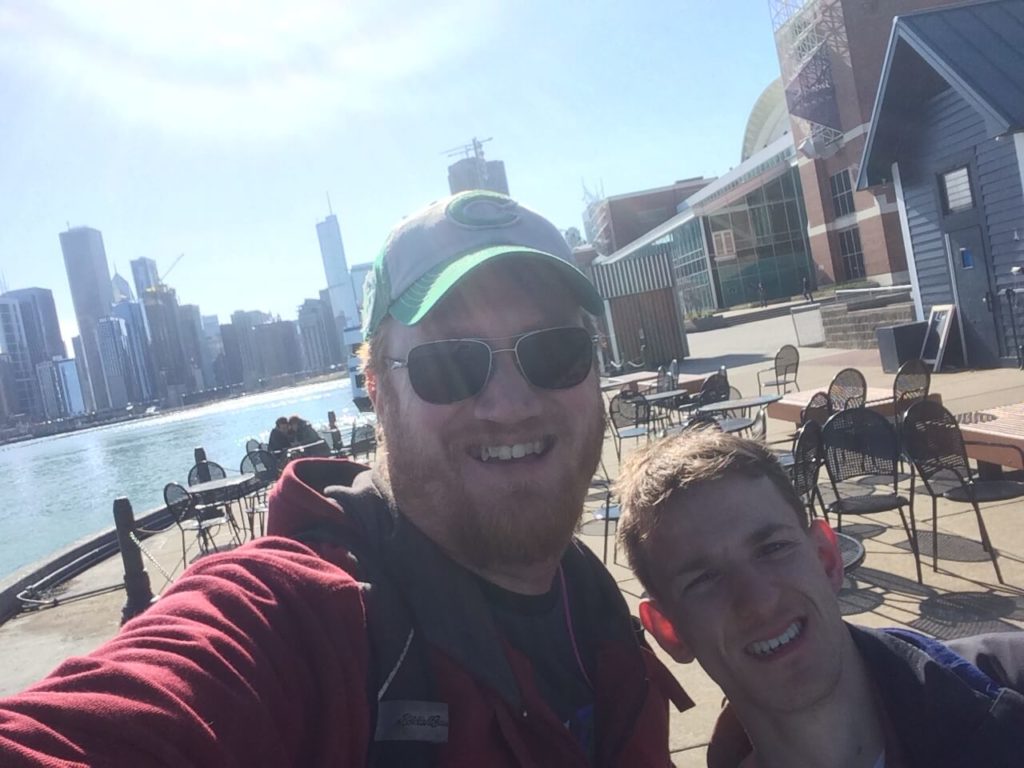 A man and teenager pose for a selfie together.