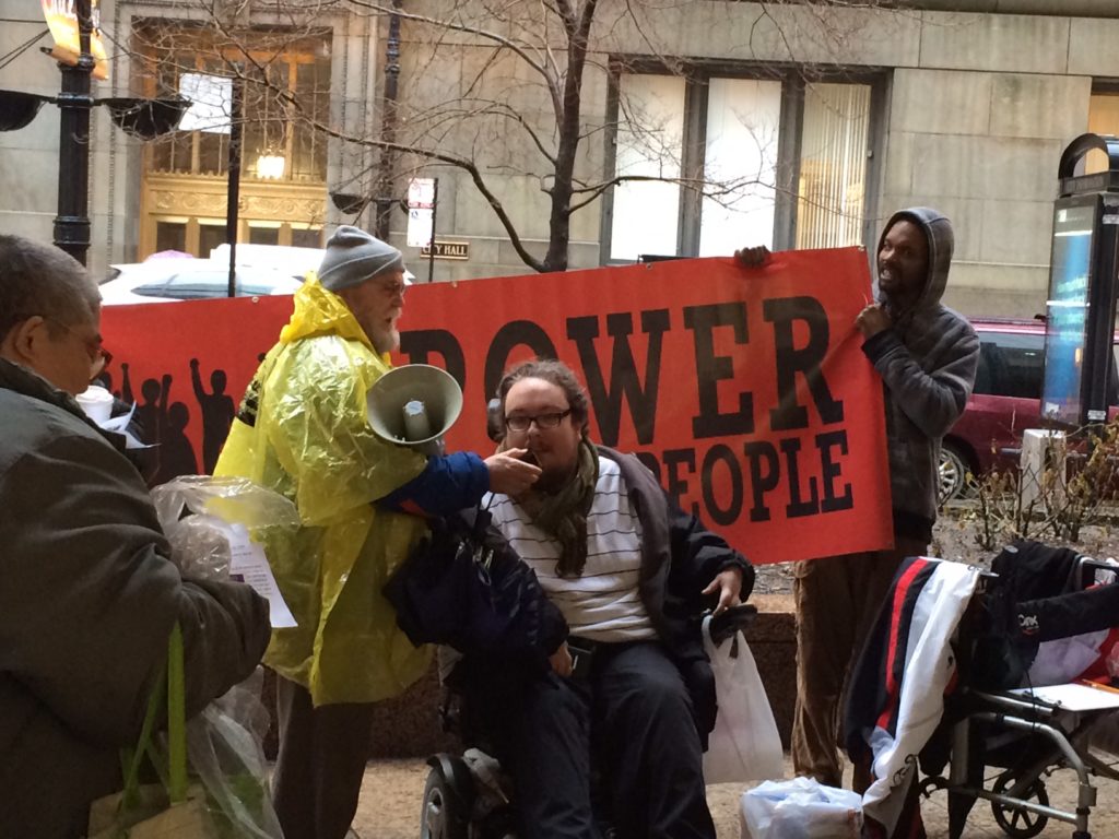 A group of advocates holding a Power to the People sign.