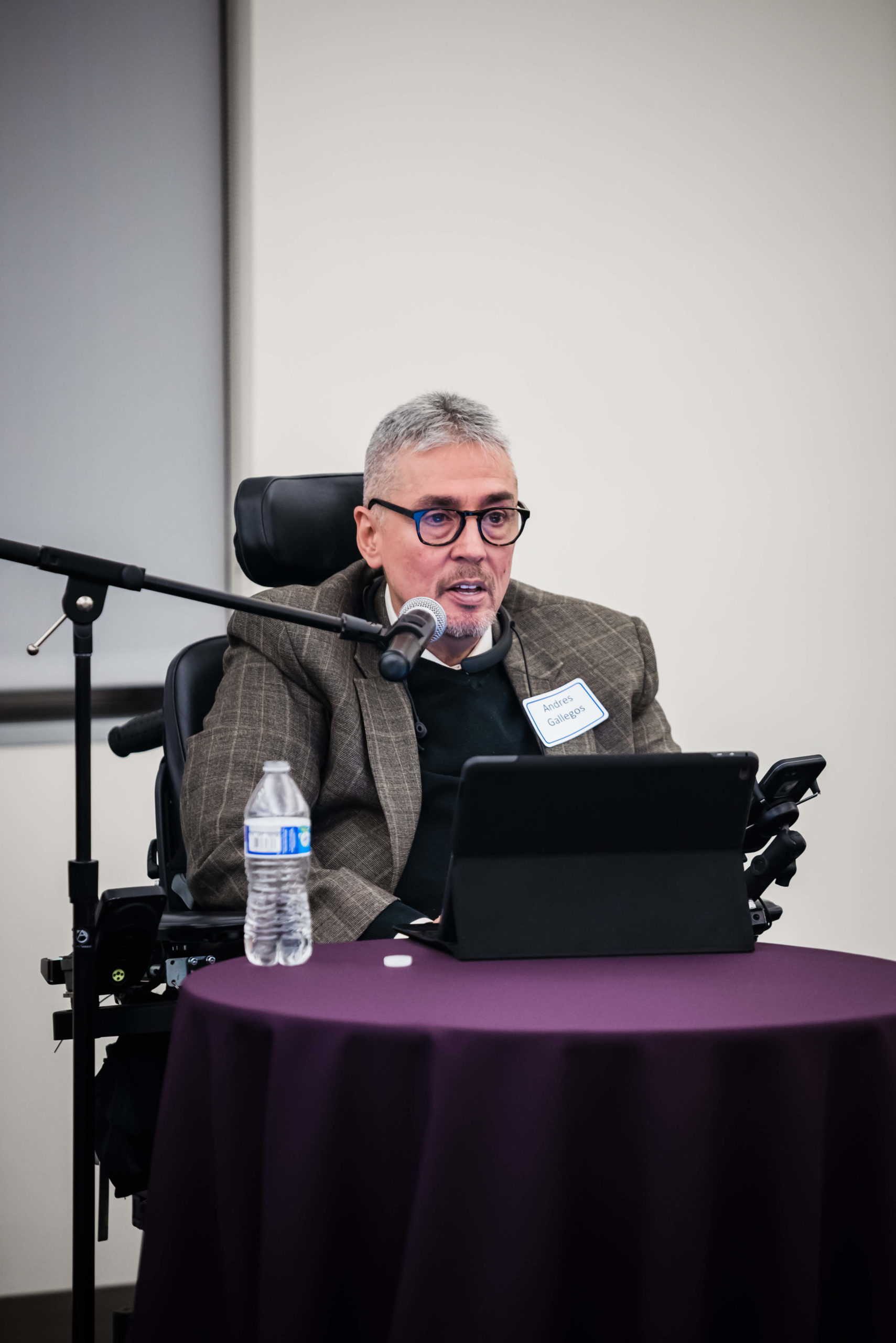 Andres Gallegos speaking into a microphone.