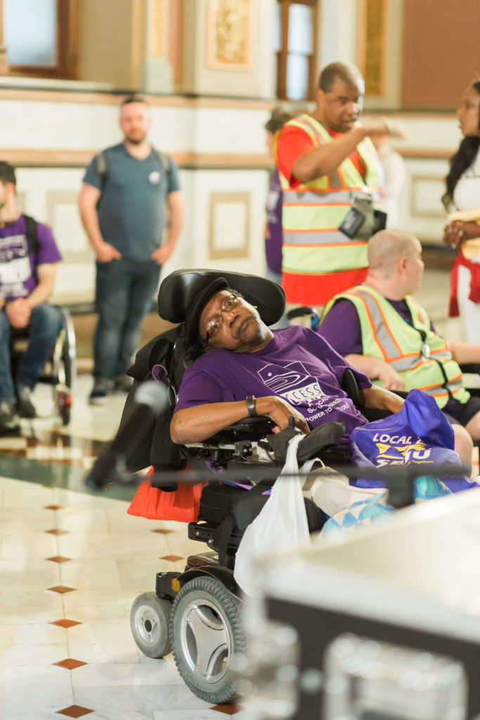 Mike Grice, a black disability activist who uses a power chair. 