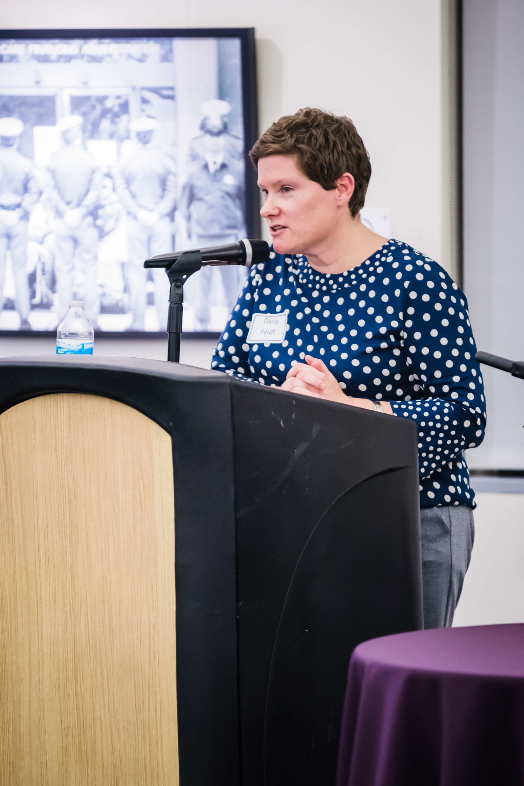 Daisy Feidt speaking at a podium.