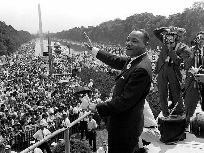 Martin Luther King, Jr. waves to the crowd gathered at the Lincoln Memorial.