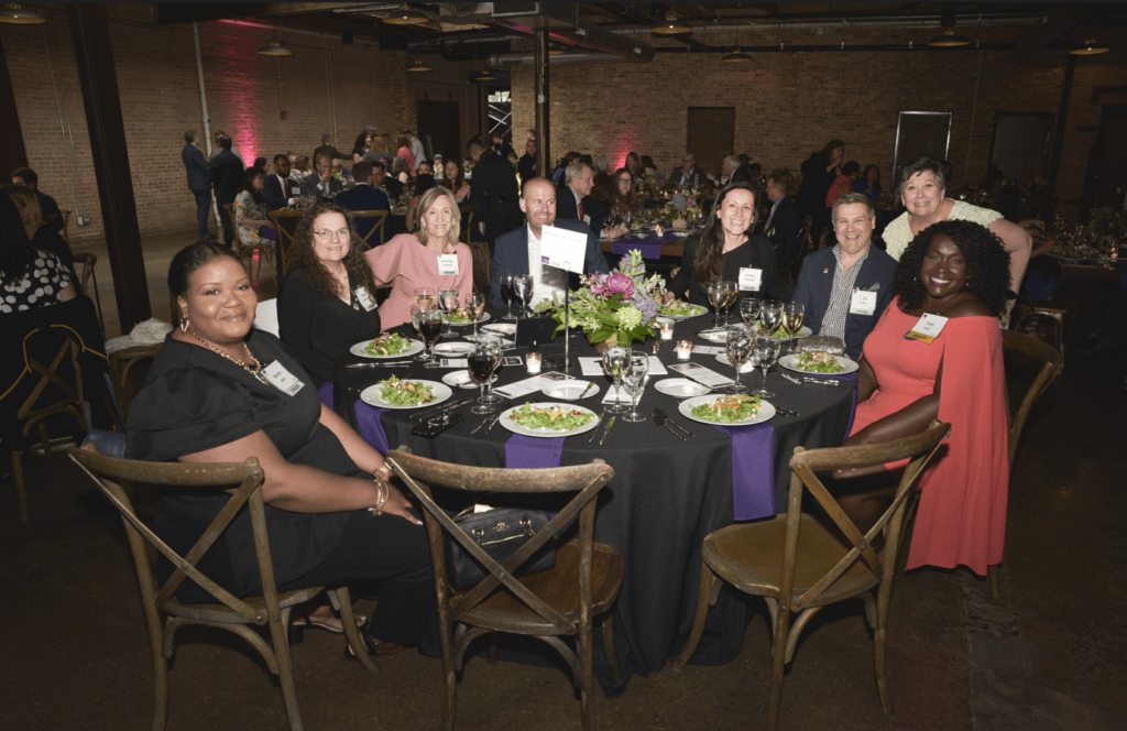 A group shot of several gala sponsors during dinner.
