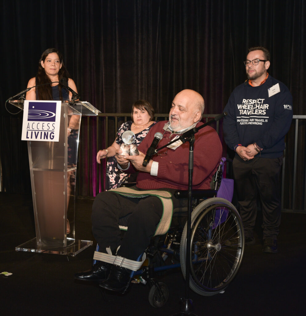 Jorge Pineada accepts the Access Living Lifetime Achievement Award on behalf of his late wife, Judy Heumann.