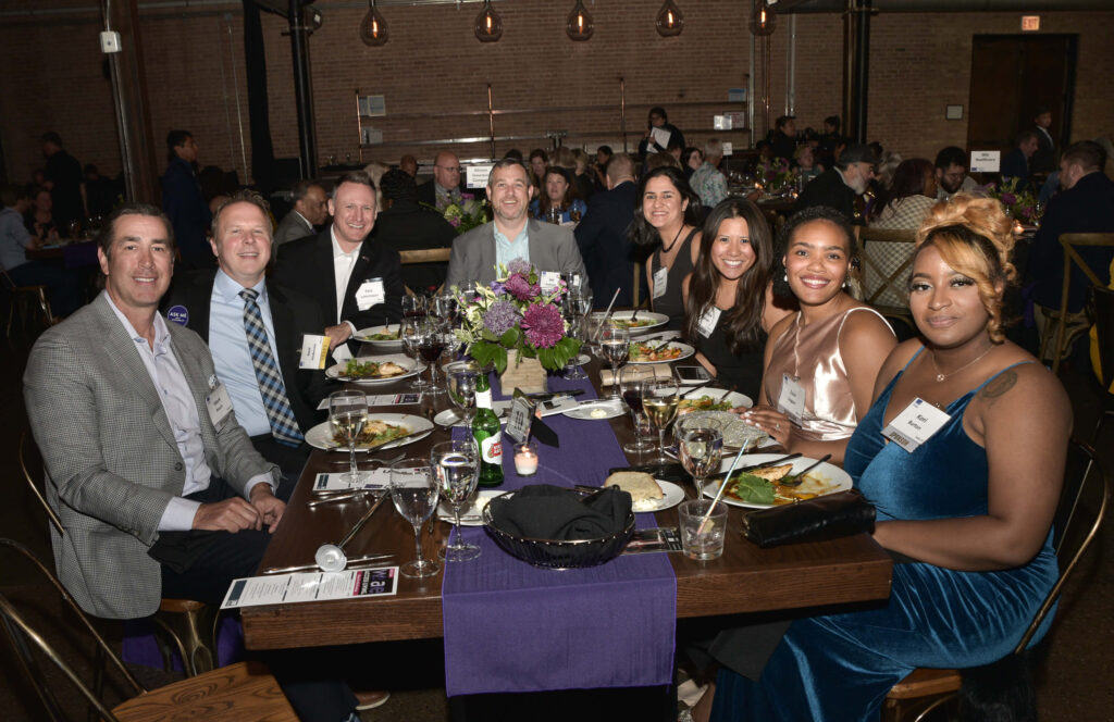 A table of sponsors and their guests during dinner.