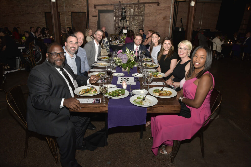 A table of sponsors and their guests during dinner.