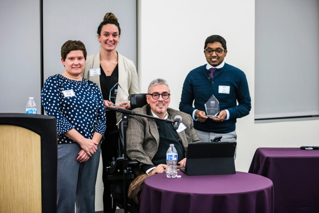 Andrés Gallegos posing with award recipients.