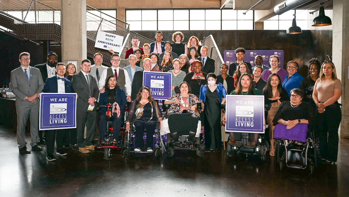 Access Living staff at the 2025 Gala holding signs that read We Are Access Living