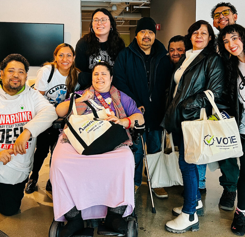 Nine Cambiando Vidas group member, eight are standing and one woman is using a wheelchair, at Access Living